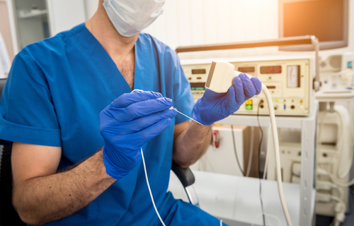 Picture of a male Medical Professional sitting next to a Electrophysiology or EP. This examines the electrical system of the heart. Electrophysiology studies are used to diagnose exactly where the irregular heart beat (arrhythmia) is coming from. Arrhythmia can be fixed using catheter based ablation procedure or by implanting a device, such as a pacemaker/ defibrillator.